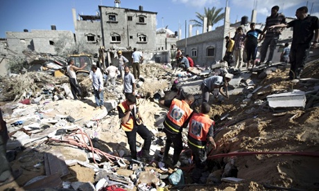 MDG : Humanitarian crisis  : Rescue workers search through the rubble of a house in Gaza
