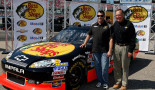 Tony Stewart (left) and Bass Pro Shops founder Johnny Morris stand beside a 2013 model of the No. 14 car. (Getty)